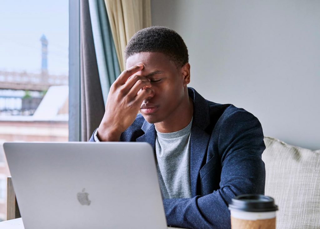 Man looking at a computer experiencing eye strain