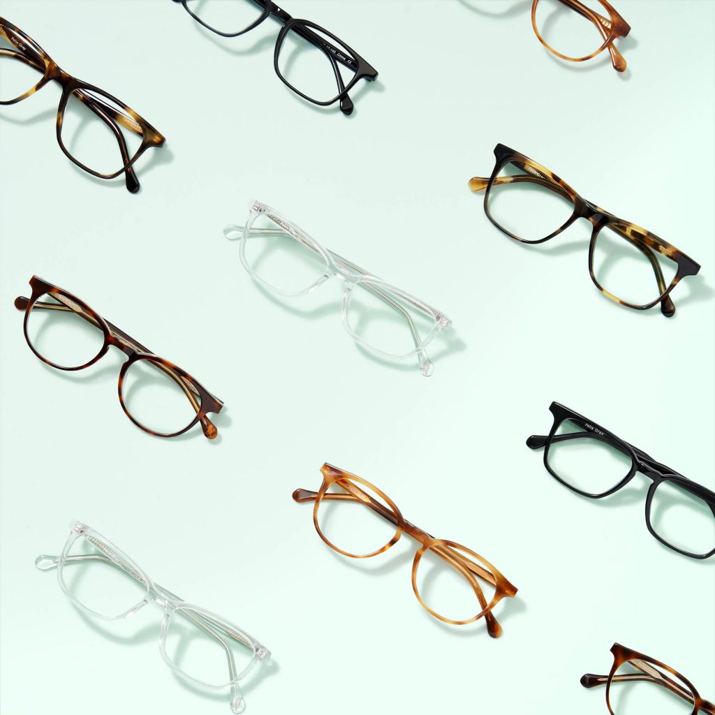 an image of multiple pairs of eyeglasses stacked in diagonal lines