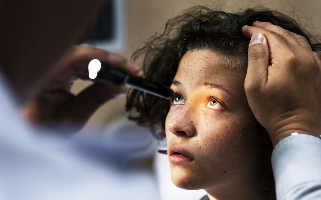Image of person getting their eyes tested with a light