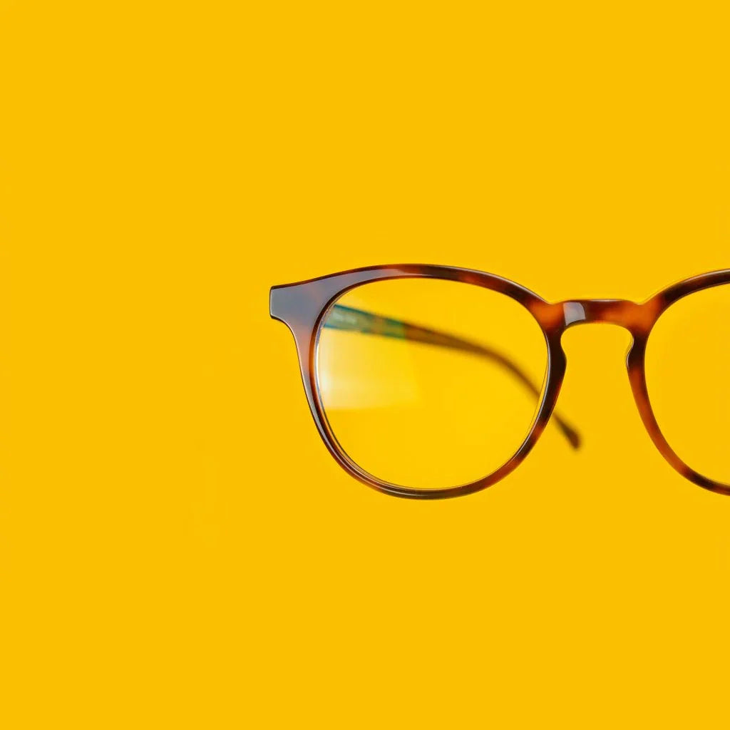 Brown tortoise Roebling glasses on yellow background