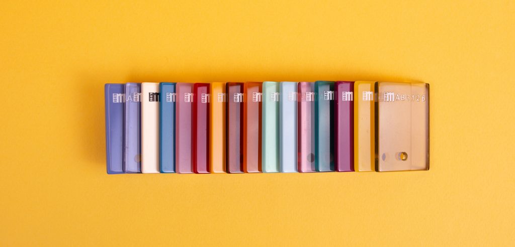 A variety of colorful acetate chips on a yellow background