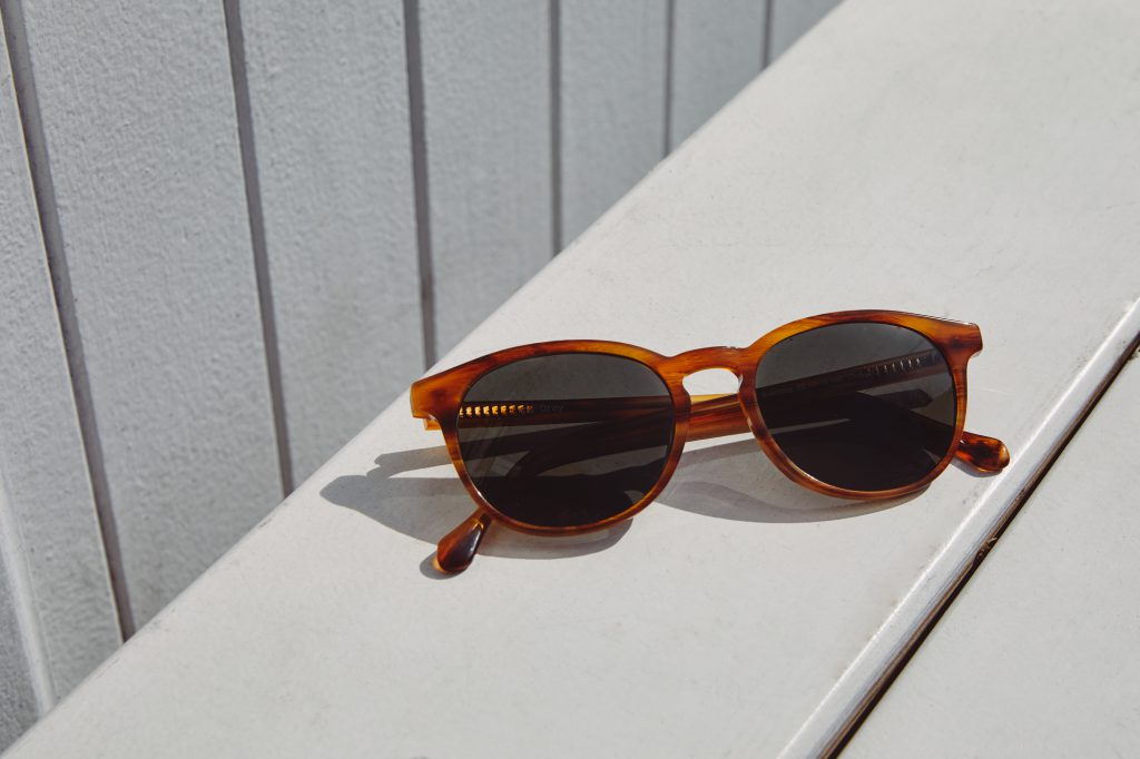 Brown Roebling sunglasses on a wood bench