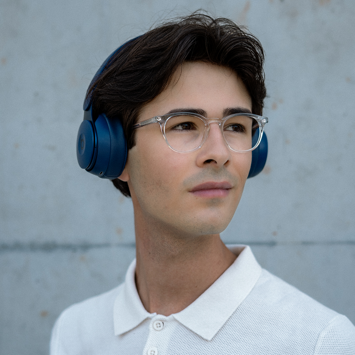 Student wearing clear glasses and headphones