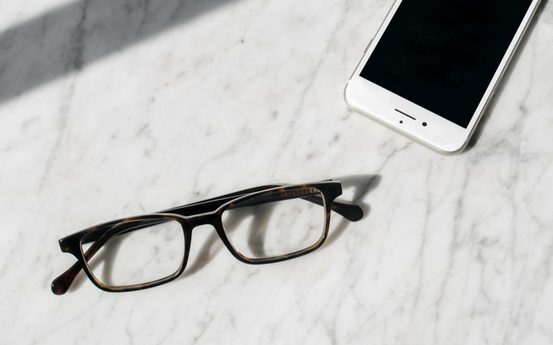 Carver eyeglasses and iPhone on a marble table
