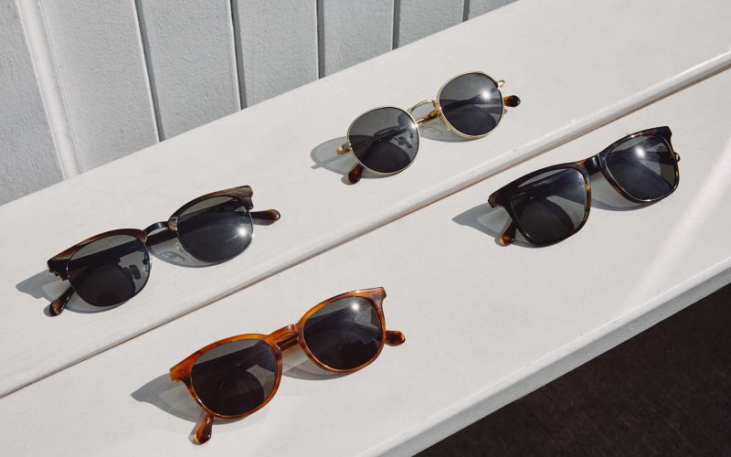 Four pairs of Felix Gray sunglasses on a wooden bench