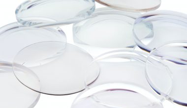 A pile of clear eyeglass lenses