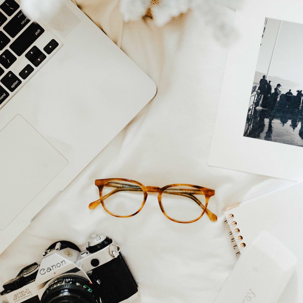 A pair of brown glasses with a computer, photo, and camera