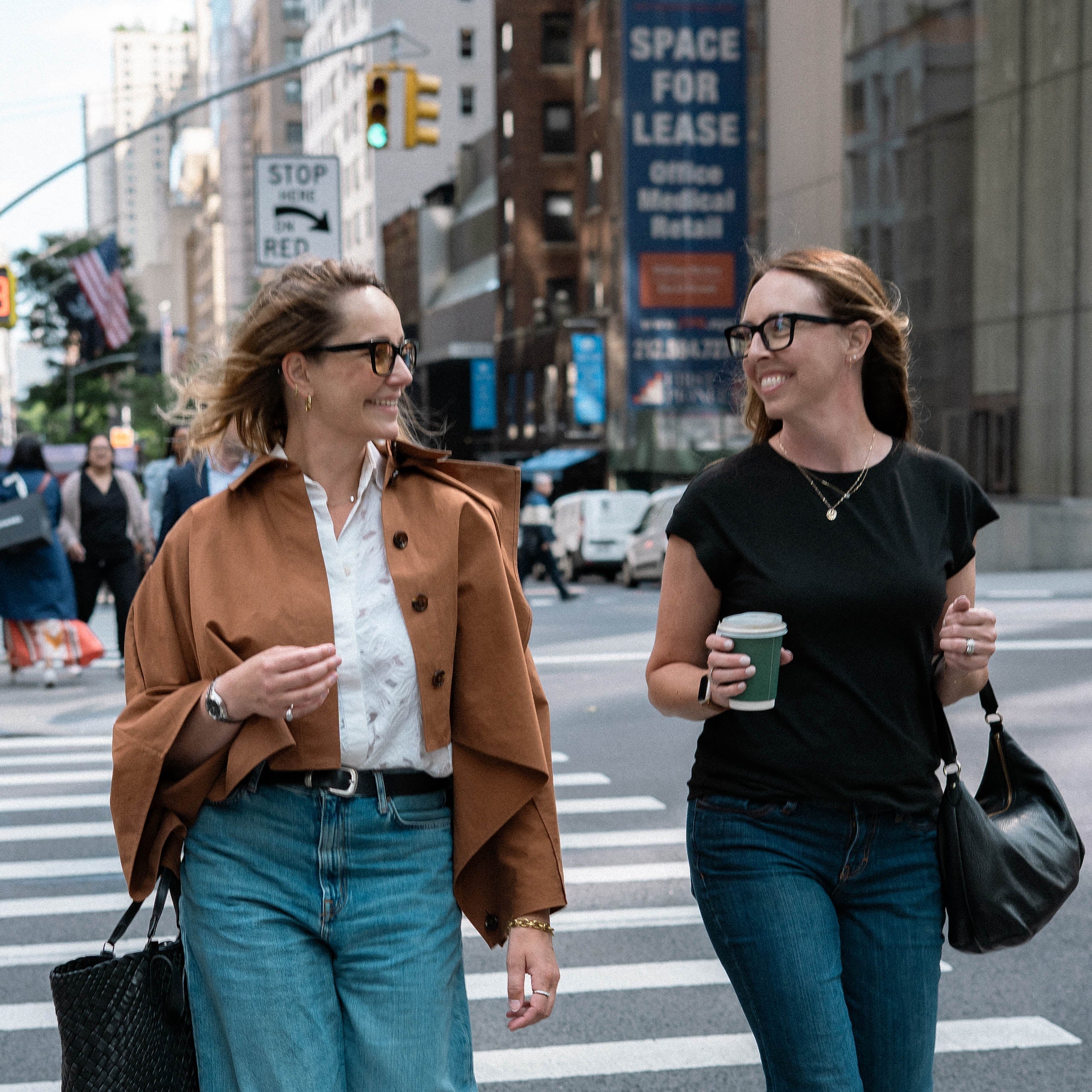 Anouk Willemen and Liz Condon smiling while crossing a street in New York