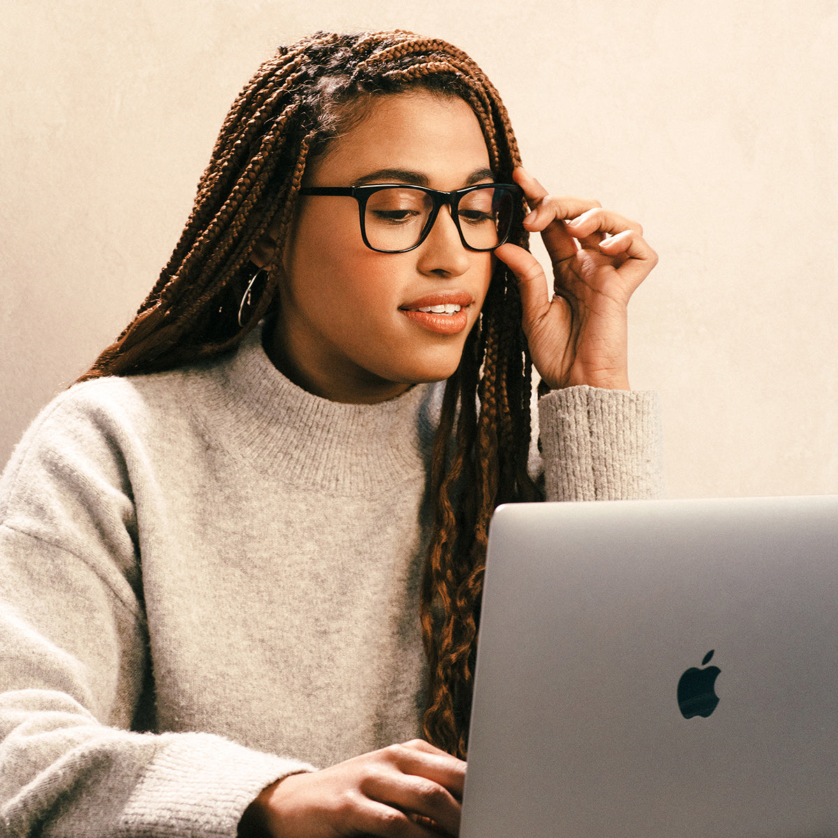 Woman wearing glasses working on computer