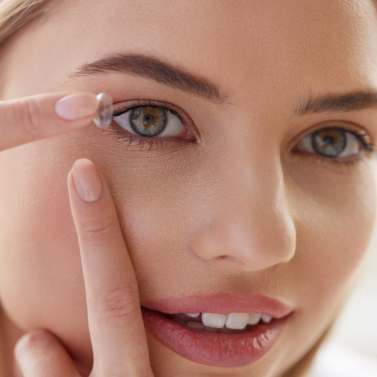 Woman putting in a contact lens