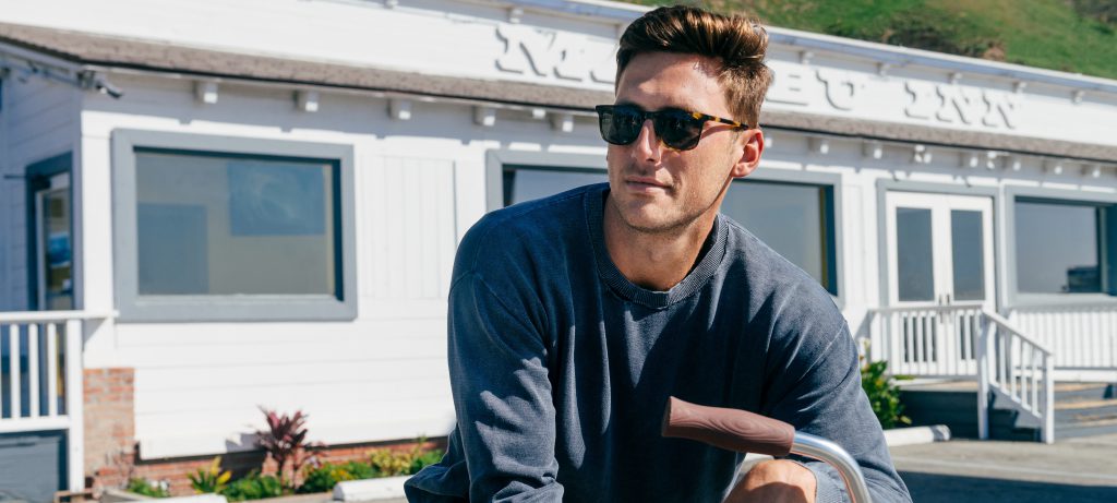 Man wearing sunglasses outside on bike