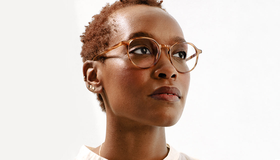 young woman wears light brown eyeglasses